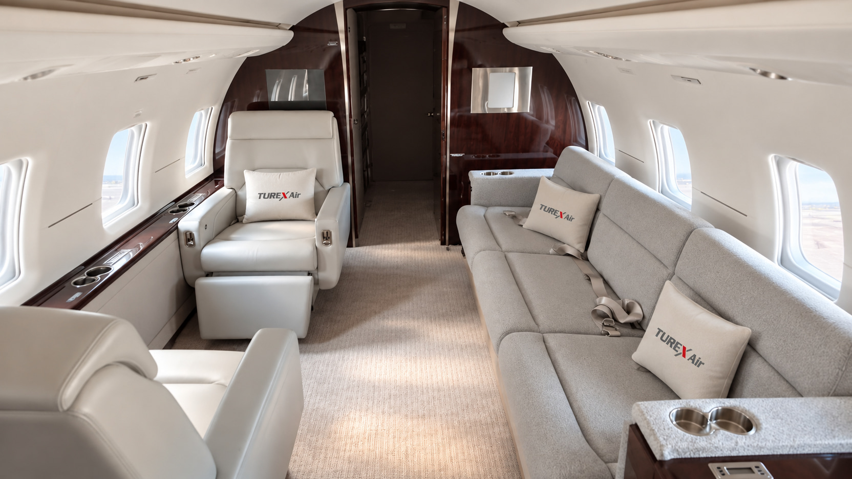 Wide divan and individual seating in the Challenger 604 cabin